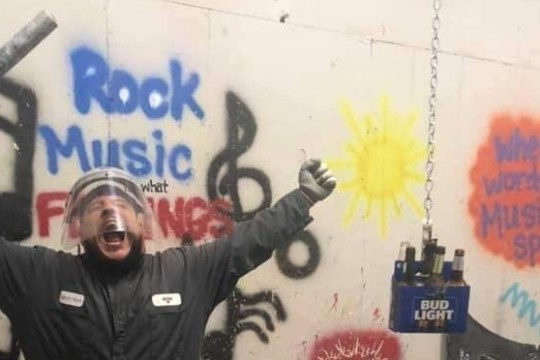 a man holding a sign posing for the camera
