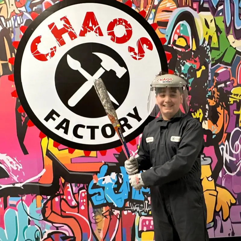 a person posing with a bat at chaos factory