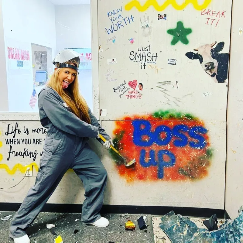 a person holding a crowbar in front of a boss up sign