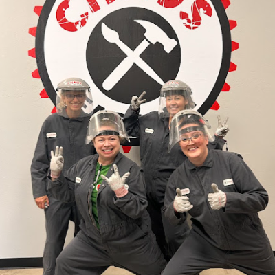 a group of people posing before they go into the rage room