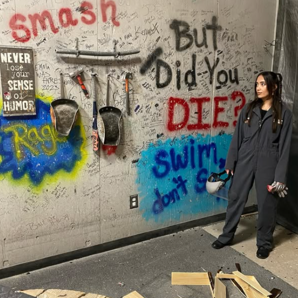 a person standing next to a graffiti covered wall
