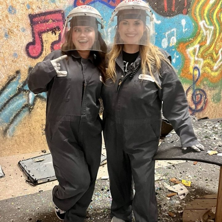 two rage room participants before they destroy the room
